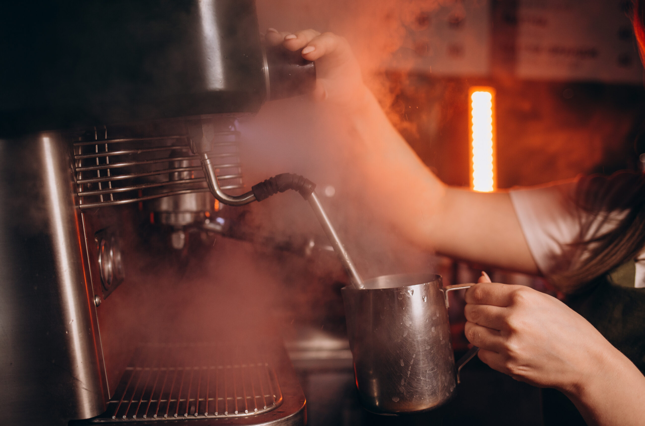 Coffee machine in steam, barista preparing coffee at cafe