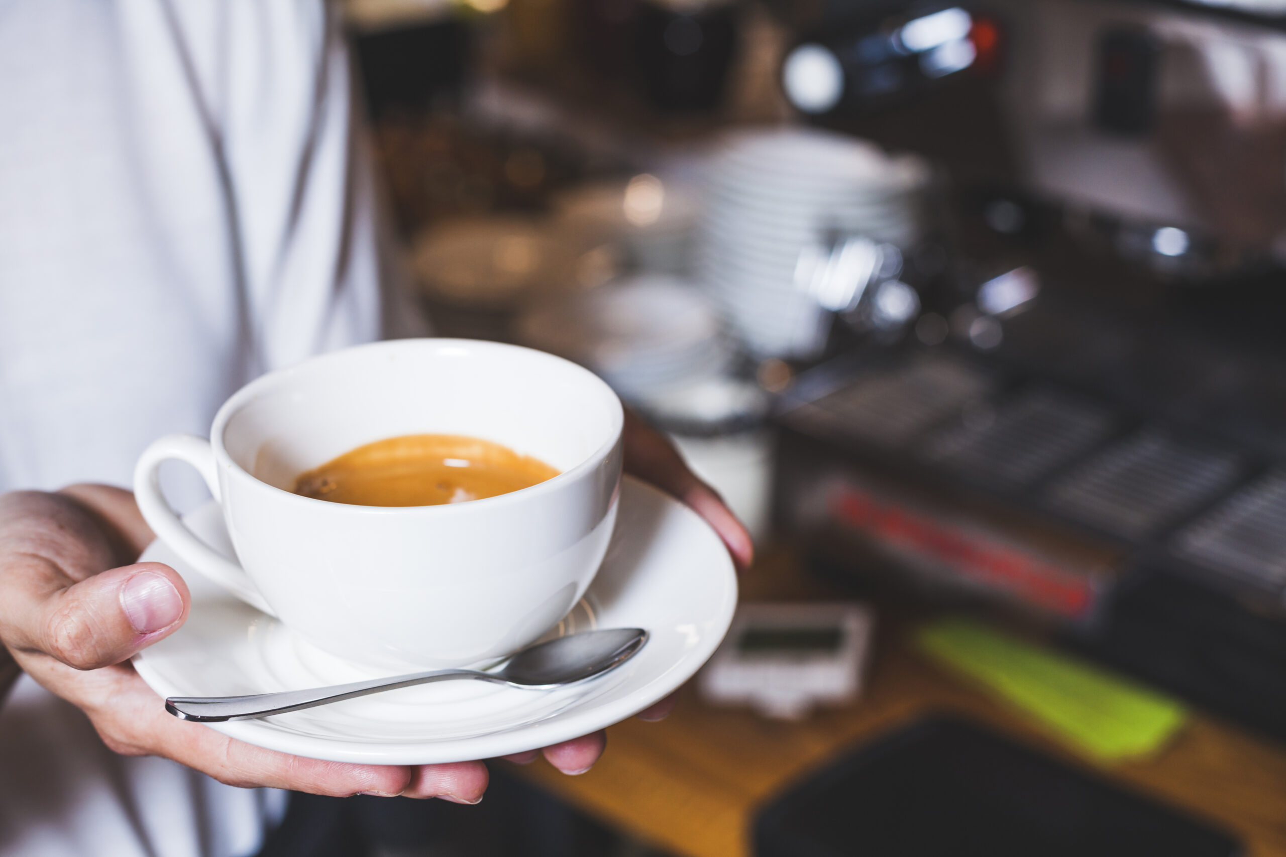 human-hand-holding-cup-coffee-cafeteria